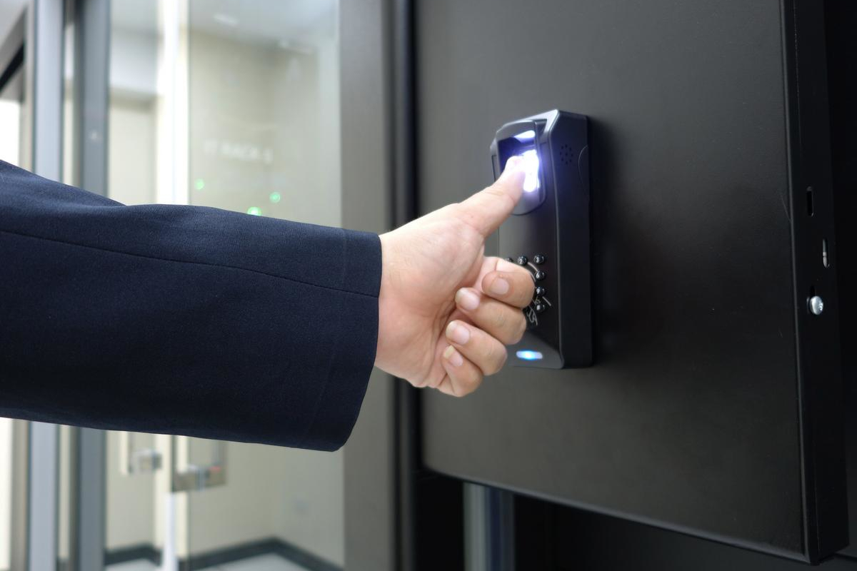 Man using fingerprint to access building