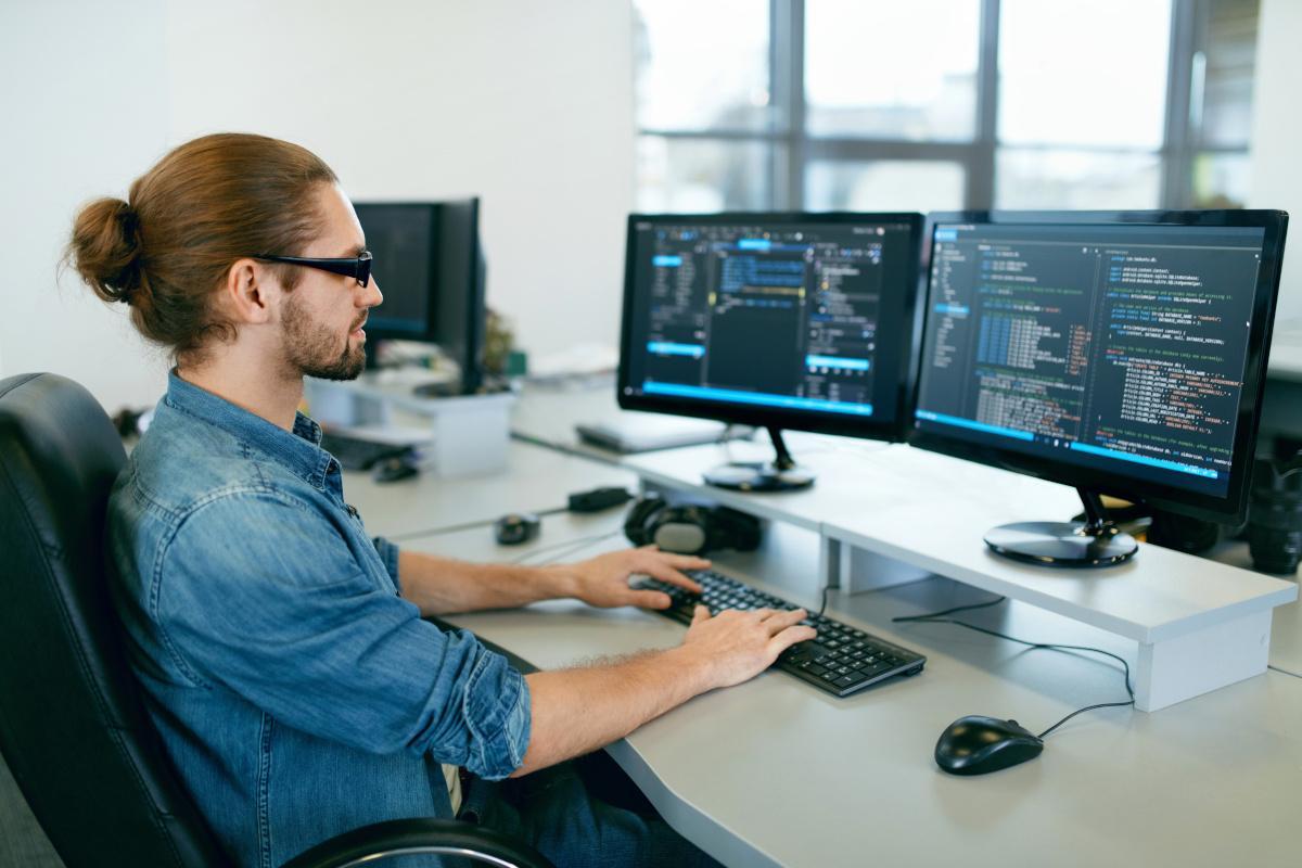 Man writing code on computer