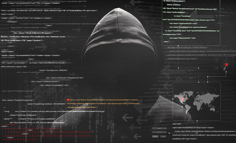 Cyber criminal in gray hoodie behind an array of scrolling code