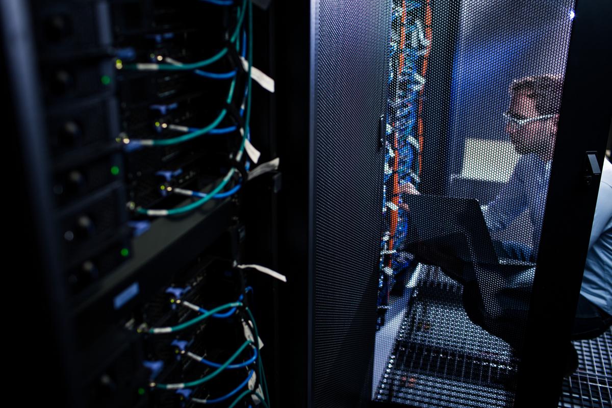 Man working in network instalation room