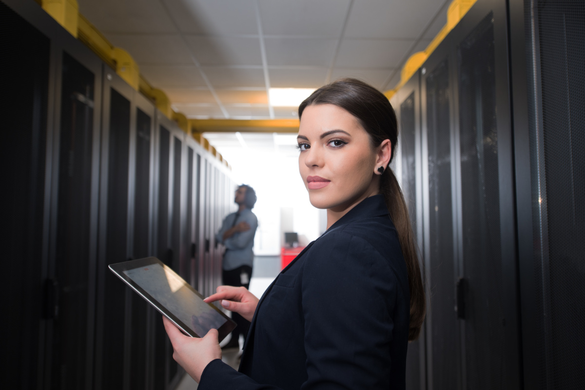 A person in a suit holding a tablet