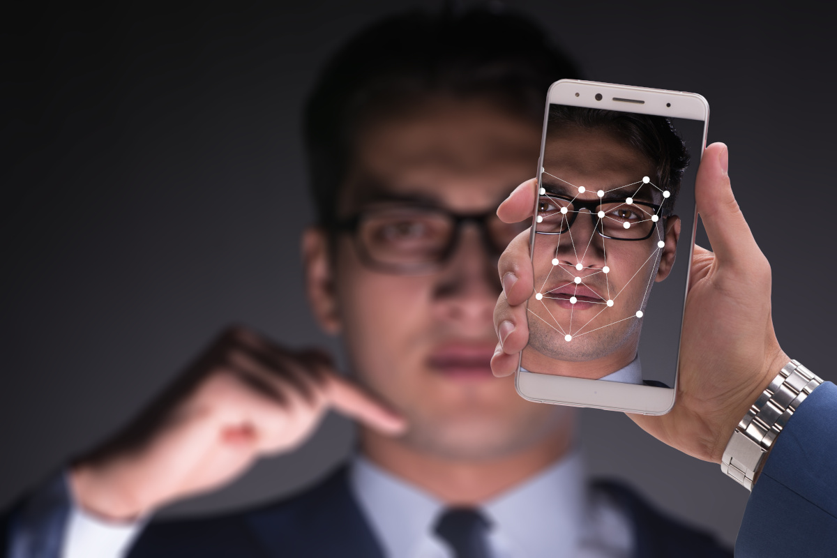 A phone being shown using facial recognition