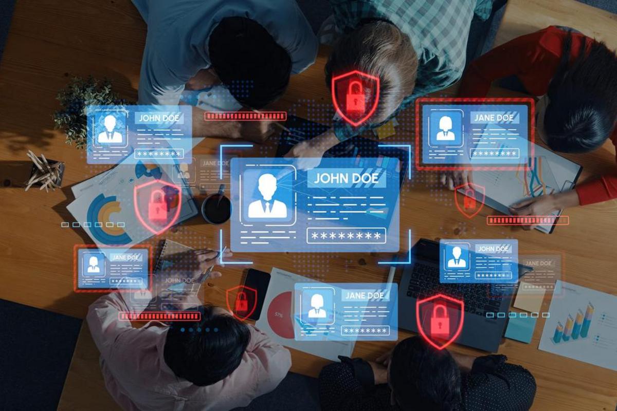 Overhead view of a team collaborating around a table with padlock and identity graphic overlays