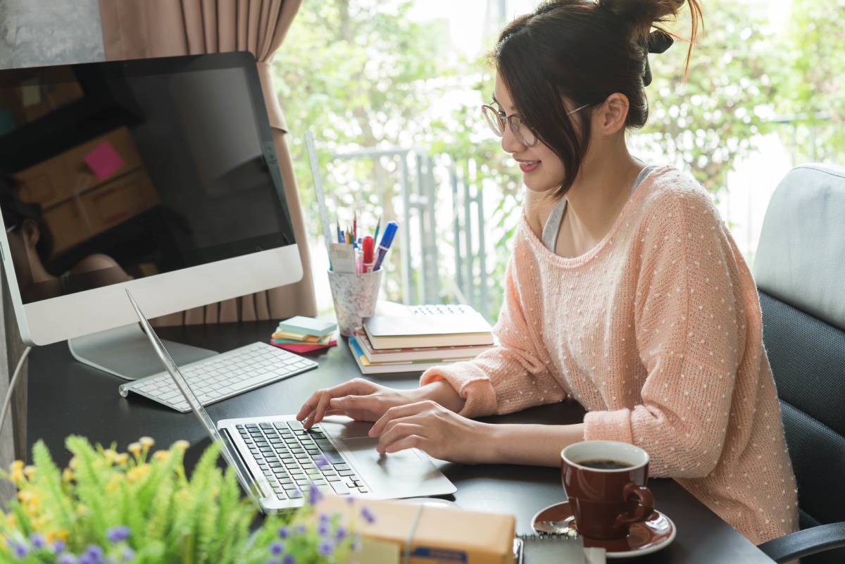 A woman working in her home office using a laptop